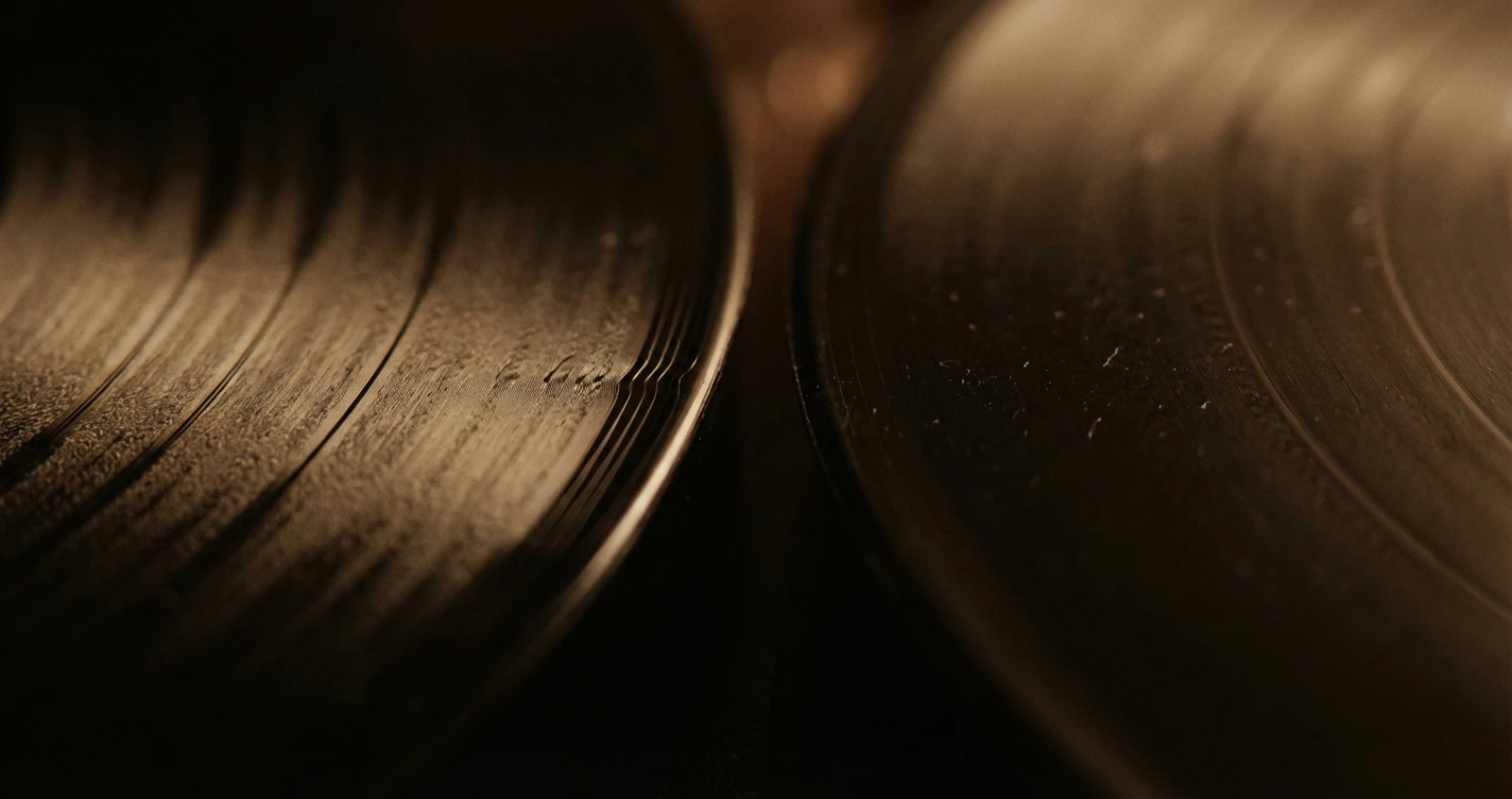A macro photograph of a record groove showing the intricate details of a half-speed mastered lacquer versus a standard cut.